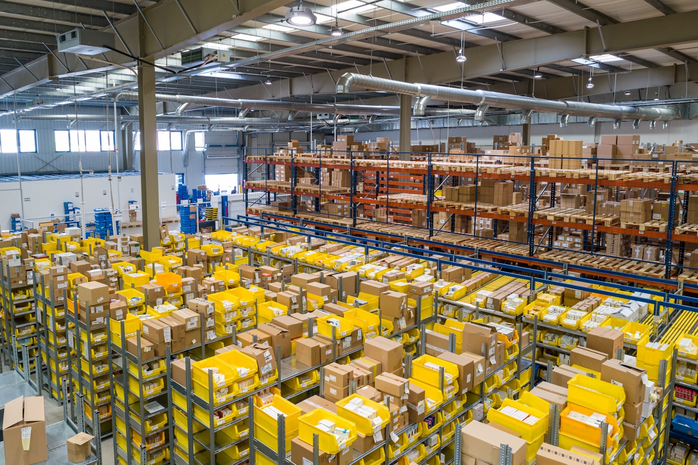 Wholesale distribution warehouse with forklift and stacked inventory